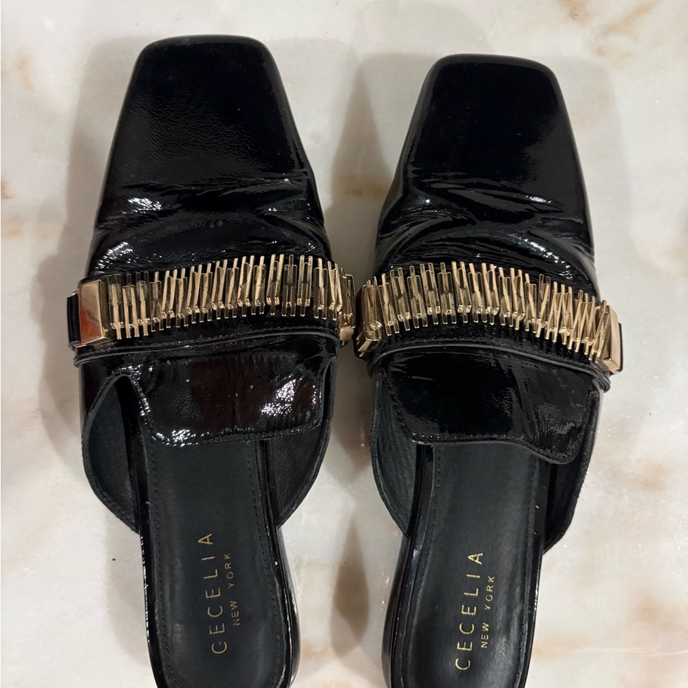 Cecelia New York Black Mules with Gold Detailing
